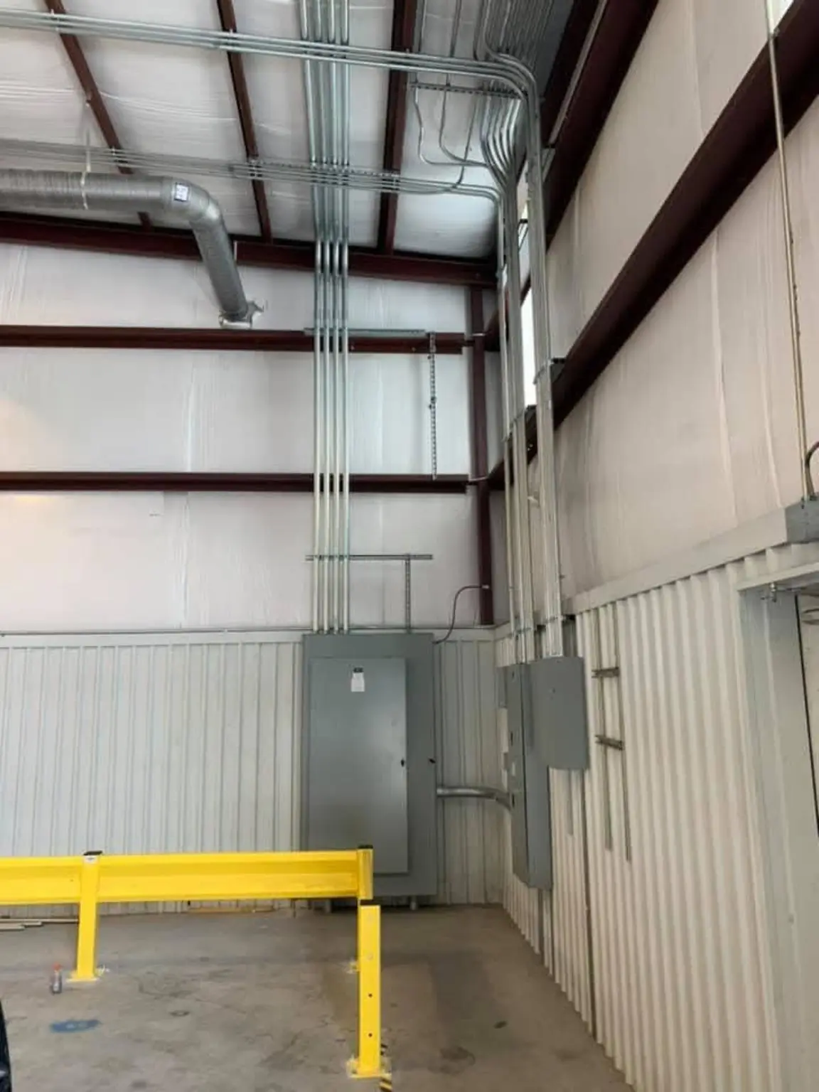 Commercial electrical conduit runs inside industrial facility