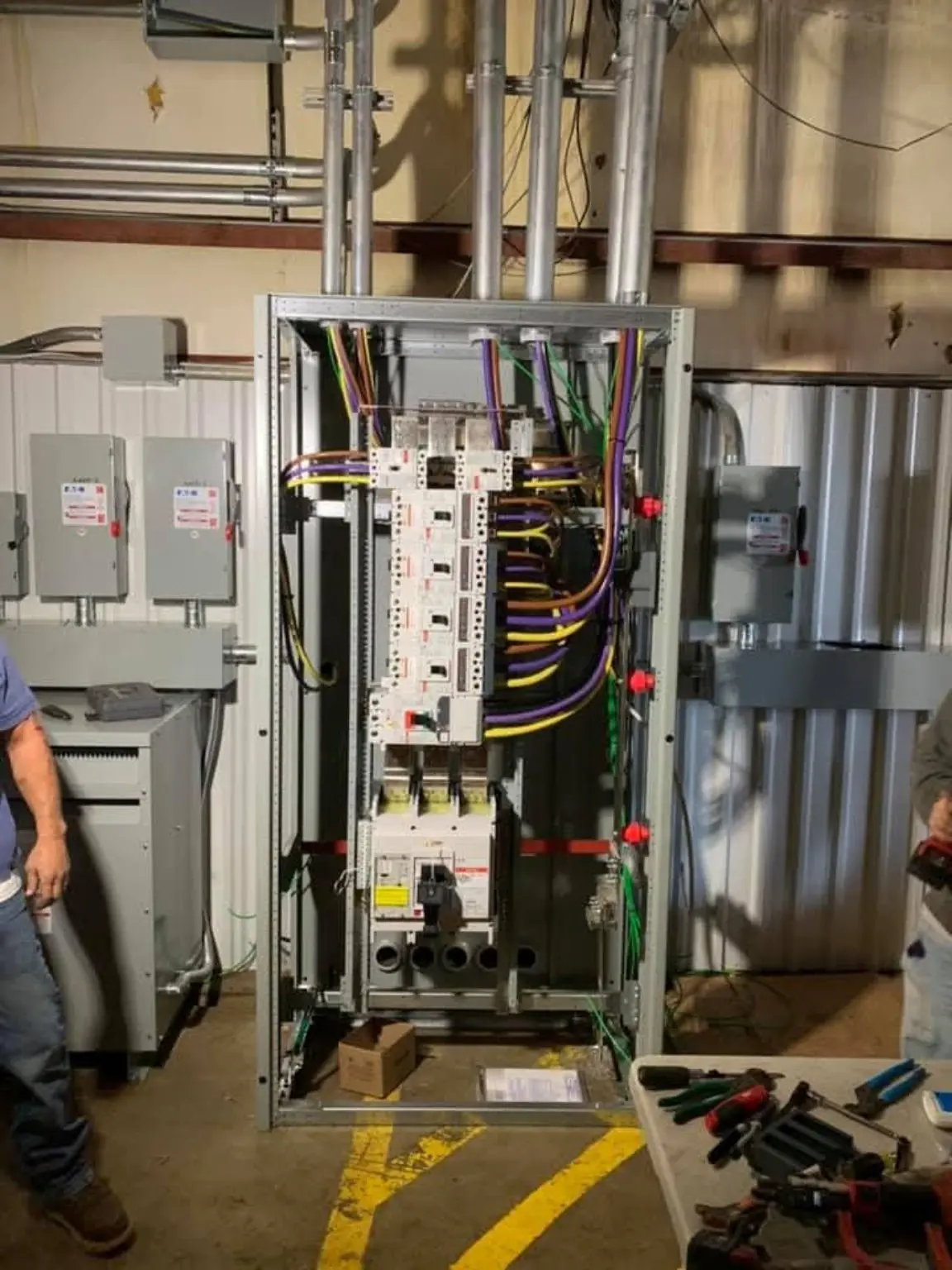Open commercial switchboard with organized feeder conductors
